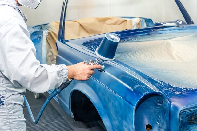 Vehicle being sprayed in the Phoenix low-bake oven workshop